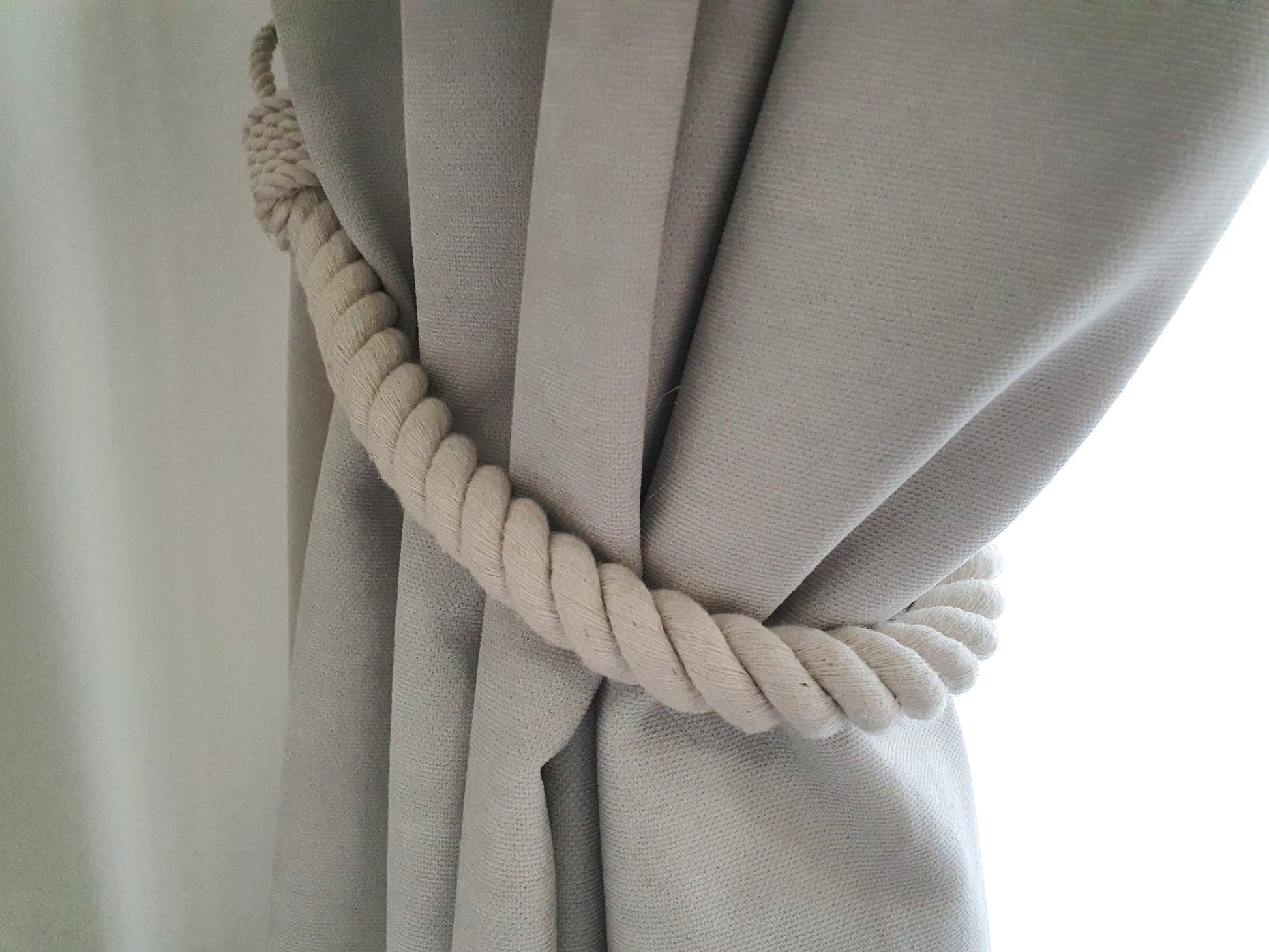White curtain with a rope tie-back, boho style farmhouse 