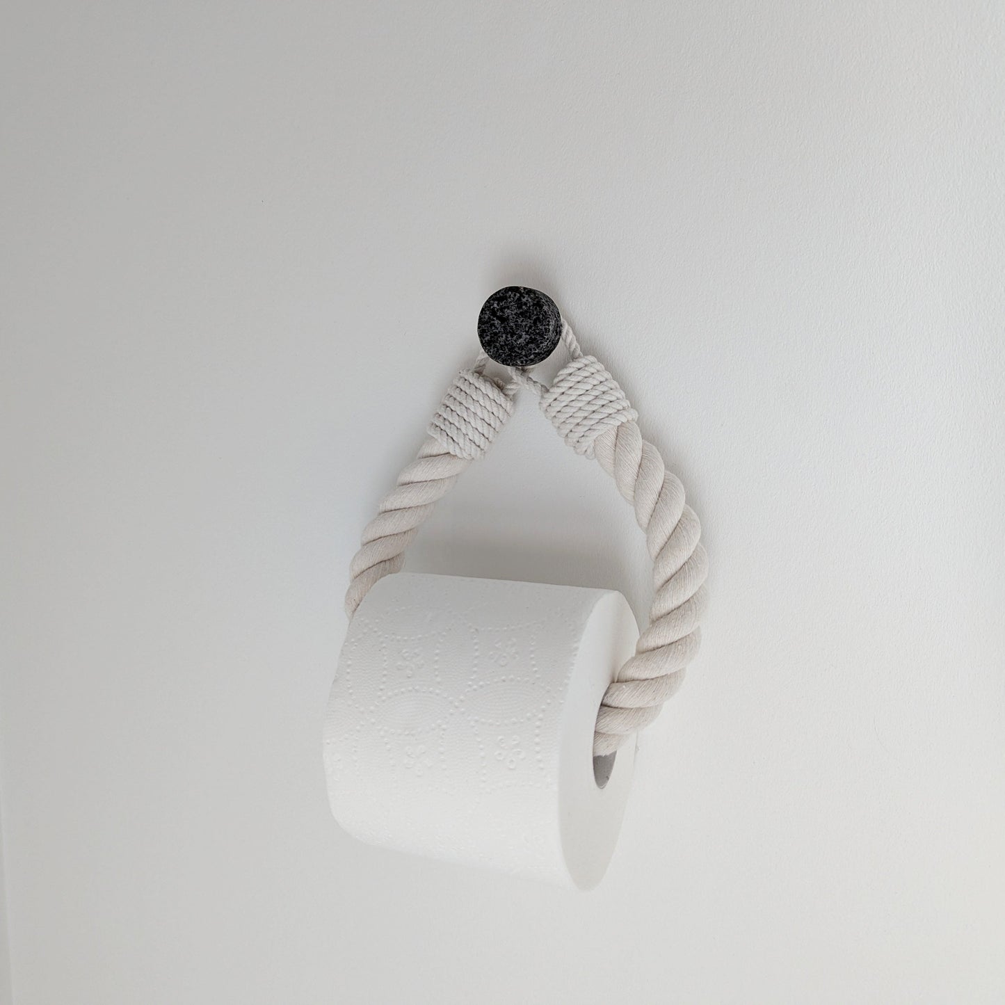 White ceramic vase with a textured design on a light gray background
