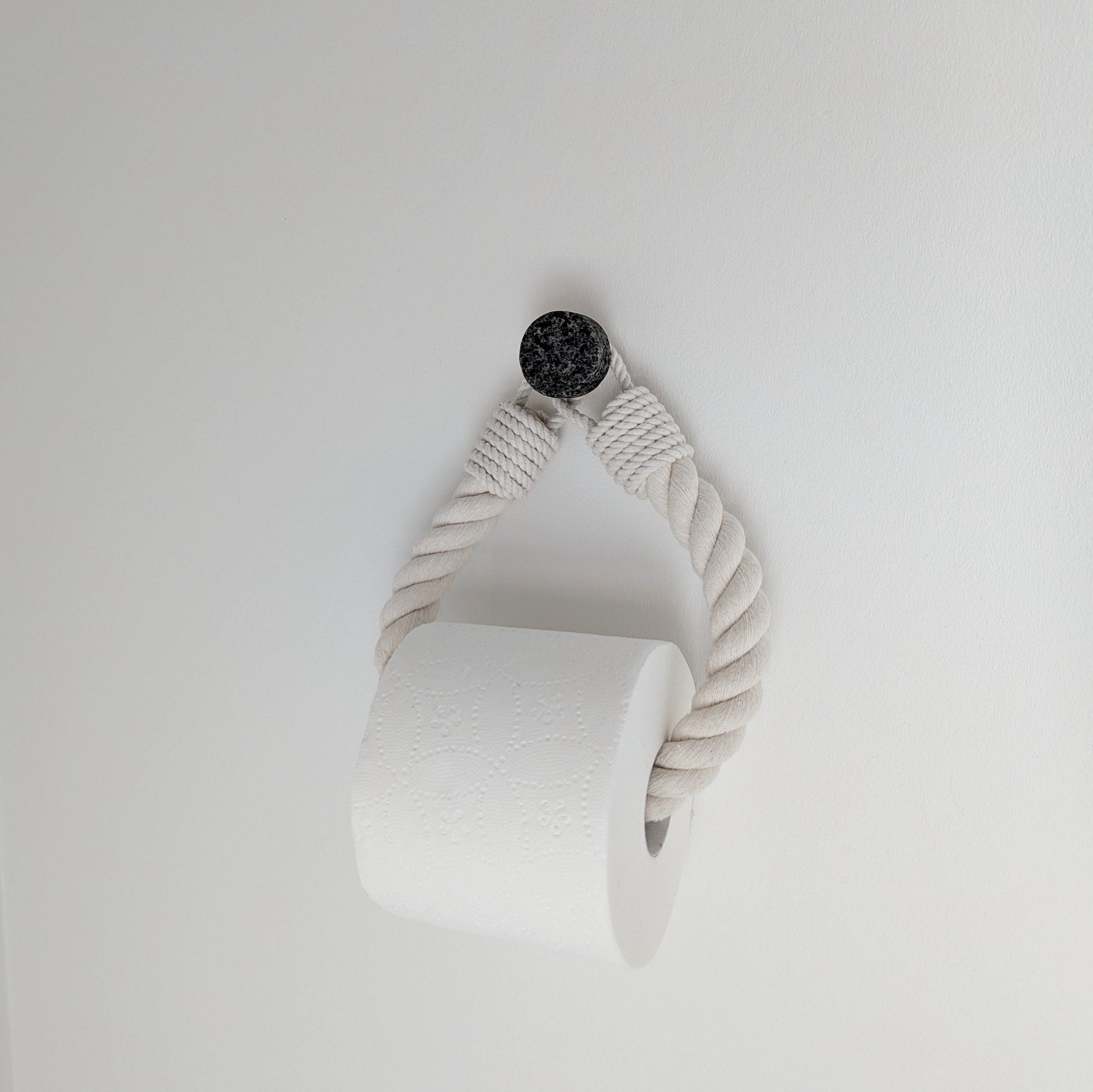 White ceramic vase with a textured design on a light gray background
