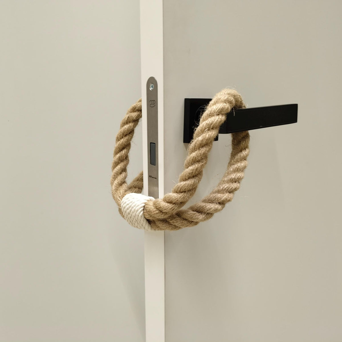Rope handle on a door with a neutral background