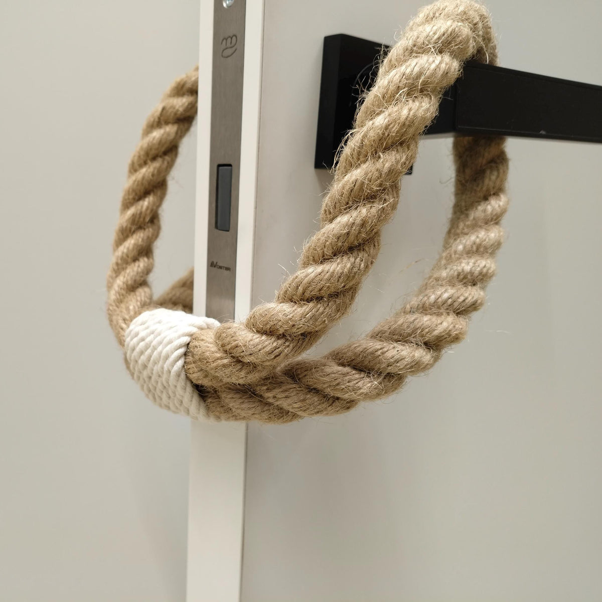 Nautical rope door handle on a white door